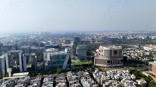 Wallpaper Mural A hazy drone shot of Gurugram shows towering corporate hubs shrouded in smog, highlighting the city’s rapid growth shadowed by severe air-quality concerns. Torontodigital.ca
