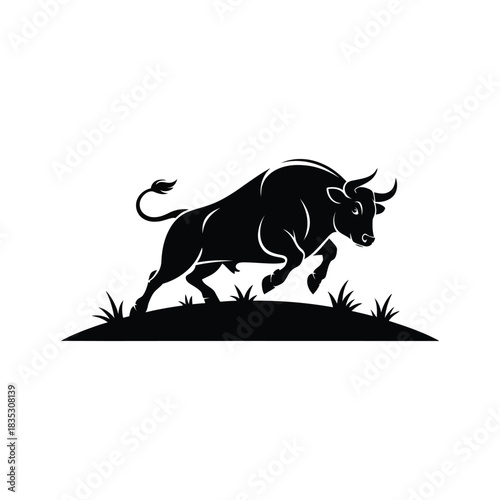 Powerful black bull silhouette charging through grass