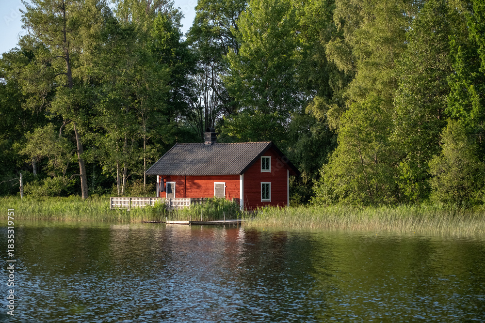 Fototapeta premium Red Swedish house by the lake