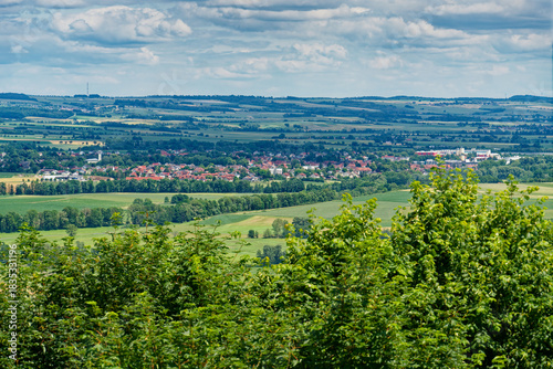 Distant view of Bad Rodach from Straufhain Ruins in Thuringia Germany, wide landscape with rolling forests and the town appearing on the horizon.