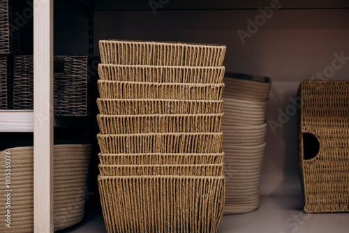 Woven storage baskets displayed on shelf in home goods store.