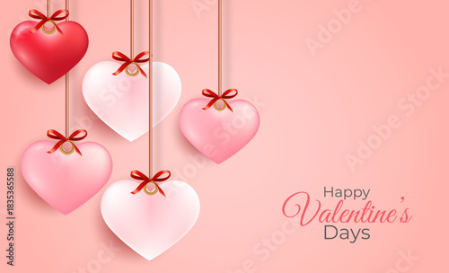 Decorative hearts in various shades of pink and red, suspended by strings with bows, against a soft pink background, celebrating Valentine's Day.