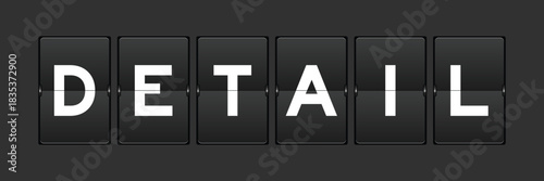 Black color analog flip board with word detail on gray background