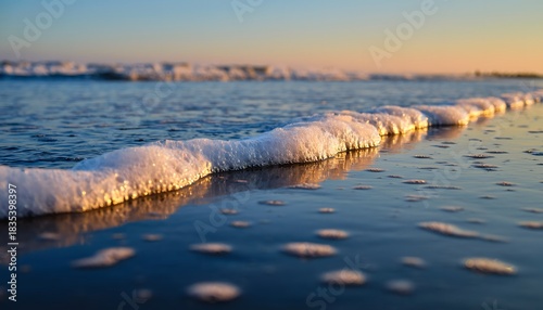 Fototapeta Naklejka Na Ścianę i Meble -  Soft Sea Foam Texture at Shoreline with Blurred Edges, Capturing Calm Coastal Waves and Natural Beach Aesthetics