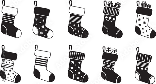 A set of black and white Christmas stockings with different patterns and designs.