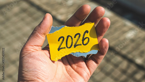 Exciting 2026 future in your hands with bright yellow paper message