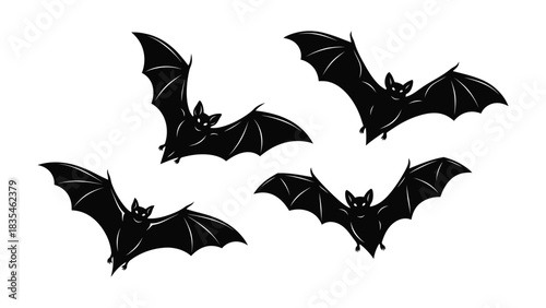 Four silhouetted black bats flying in different poses against a white background
