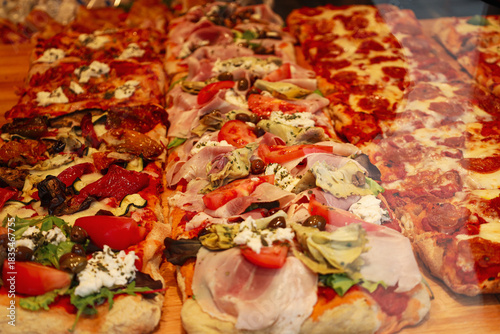 Canvas Print Close-up of Freshly Made Gourmet Roman Pizza al Taglio Slices with Ham, Artichok