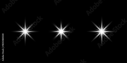 Three bright white starburst light effects on black