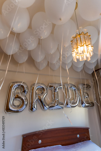 Balloon decoration in a room for a wedding celebration with a sign that says bride