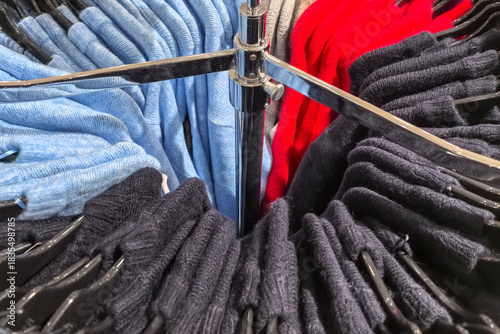 Colorful sweaters arranged on display in a cozy retail store