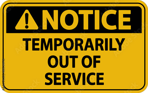 Notice sign indicating temporary out of service status with bold yellow background and black text for safety or maintenance