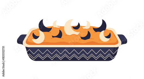 A festive, sweet potato or pumpkin casserole, baked in a dark blue dish with a zigzag pattern, topped with dark and light crescent moon shapes.