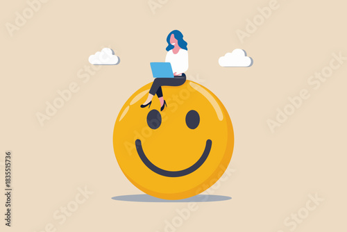 Happy and productive woman working on laptop atop a smiley face