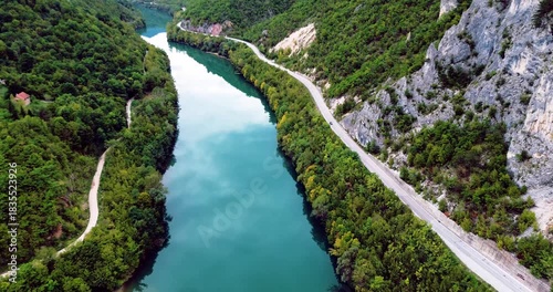Aerial view flying over turquoise river canyon