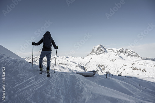 Ski tourers near Warth am Arlberg with a scenic view of the snow-covered Widderstein mountain in winter, Arlberg region, Tyrol, Austria.