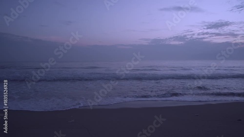 Sunrise over the ocean, with sand beach.