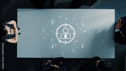 A business meeting depicting a strategic approach to targeting ideal customers, enhanced by a graphic illustration displaying human figures in focus. Raster