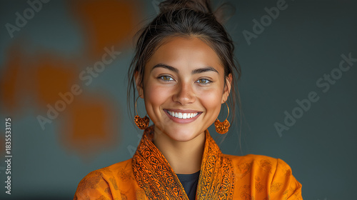 Smiling Young Woman in Bohemian Style Orange Clothing and Earrings - Vibrant Portrait Photography with Casual Ethnic Wear in an Indoor Studio Setting