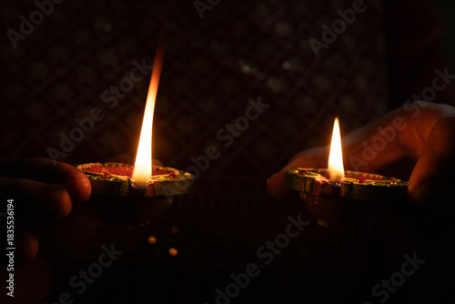 Women holds 2 oil candle to prepare for the Karthigai deepam celebration in Tamil Nadu