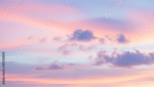 Fototapeta Naklejka Na Ścianę i Meble -  Soft pastel sky with pink and lavender hues and scattered clouds creating a dreamy atmosphere view