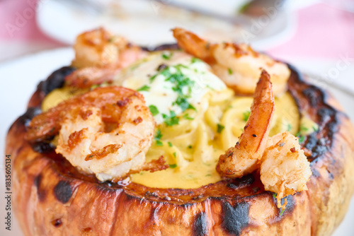 Shrimp pasta dish serving roasted pumpkin bowl