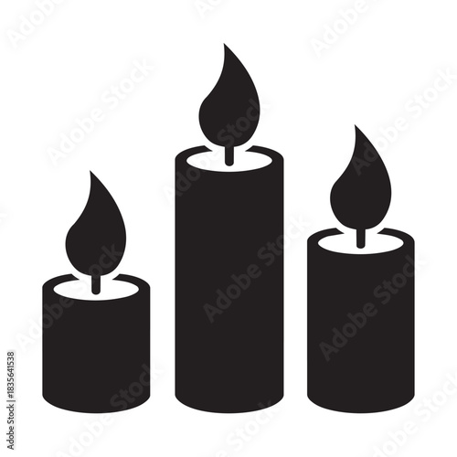 Three lit candles of varying heights flame burning