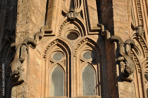 A close-up of the Sagrada Família’s intricate façade, highlighting Gaudí’s organic forms, sculpted creatures, and Gothic-inspired window details in warm afternoon light.