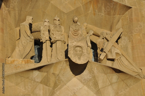 A dramatic close-up of the Passion Façade sculptures at Sagrada Família, highlighting angular forms and expressive stone figures carved by Josep Maria Subirachs.