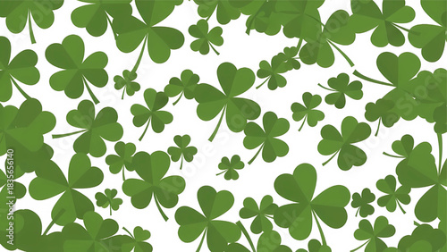 A dense and scattered background pattern of various shades of green clovers and shamrocks against a clean white background. Nature and luck motif.