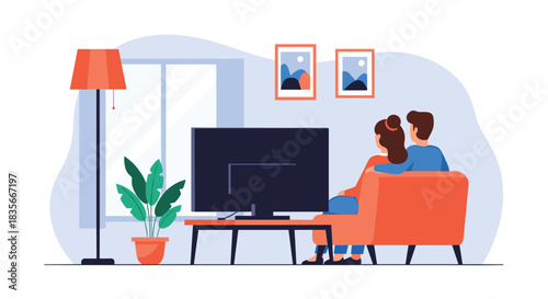 Young couple cuddling on the sofa and watching a movie on television together in their cozy and modern living room at home.