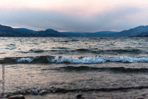 Rough waves on Okanagan Lake and storm clouds at sunset during summer thunderstorm