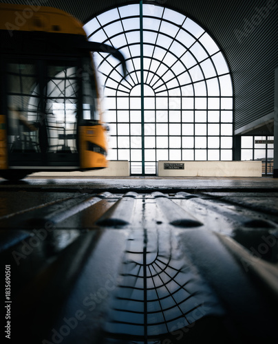 Canvas Print yellow bus in motion in front of a large window