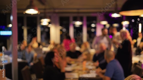 Lively dining celebration, Energetic banquet space teeming with guests and fastmoving service personnel