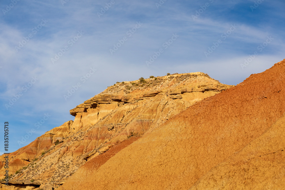 Fototapeta premium Majestic sandstone formations rise against a clear blue sky in the vast desert landscape