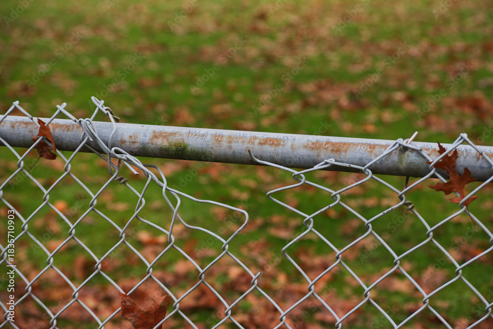 Naklejka premium Broken chain link fence