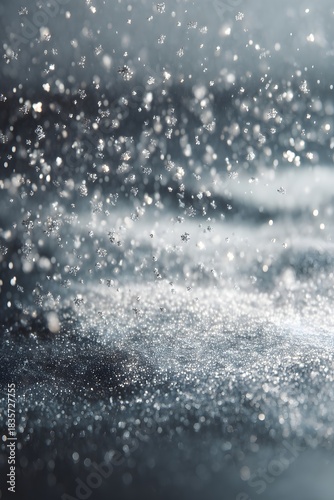 Minimal icy blue winter scene with soft snow falling and glowing silver particles. Perfect for elegant holiday designs and clean seasonal compositions.