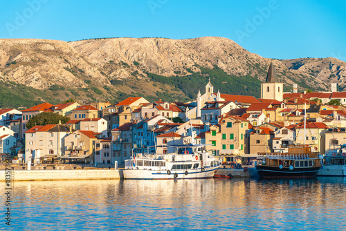 Wallpaper Mural Coastal townscape with boats in harbor against mountain backdrop. Baška, Krk island, Croatia Torontodigital.ca