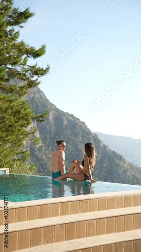 A couple sharing romantic moments by the pool during their holiday, enjoying privacy, warm sunlight, and a relaxed luxury vacation atmosphere.