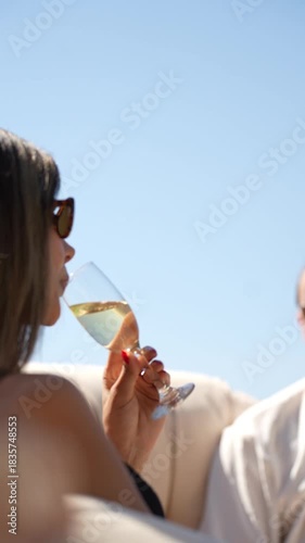 A couple sharing a romantic moment on a hotel balcony with a stunning sea view, enjoying privacy, warm light, and a peaceful holiday atmosphere by the coast.