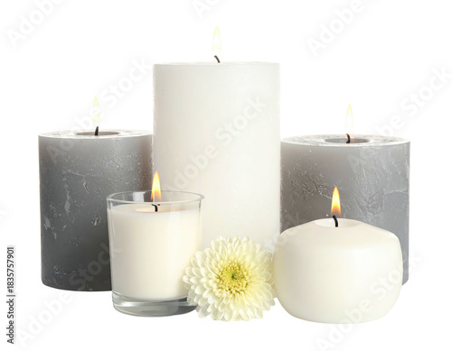 Various lit candles of different sizes and shapes, with a white flower, on a transparent background