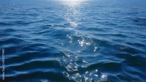 Sparkling blue ocean water sunlight reflection gentle waves calm sea horizon shimmering blue water sea sunlight reflection wave horizon