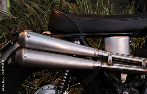 Close-up of the exhaust pipe of a vintage motorcycle.