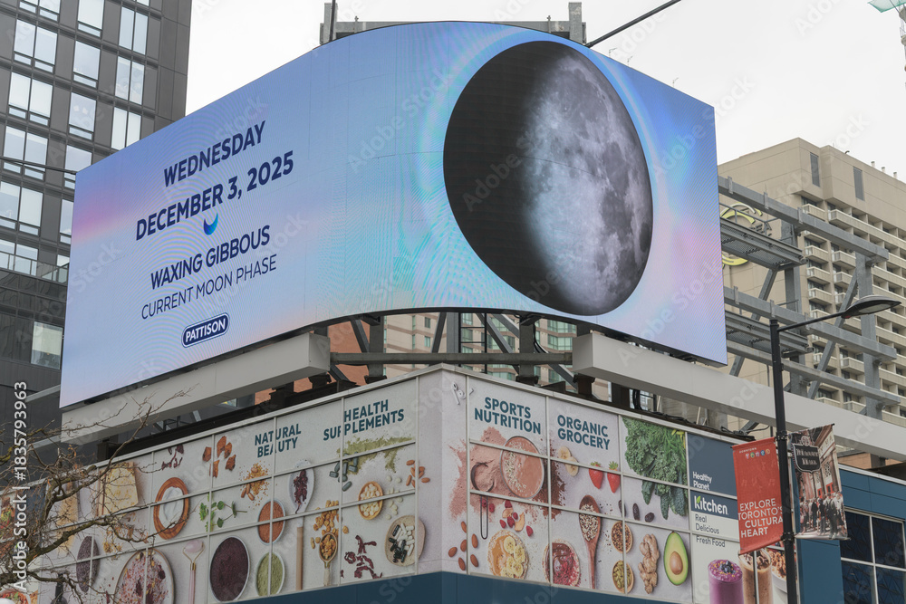 Fototapeta premium outdoor media company Pattison moon phase sign rooftop of Healthy Planet - Yonge & Dundas, Toronto
