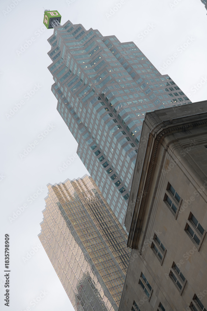 Naklejka premium oblique skyward angled view of TD Canada Trust Tower and Royal Bank Plaza contrast with historic building, Front St W, Toronto