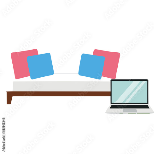 White couch with pink and blue cushions and a laptop on the side in a simple interior setting