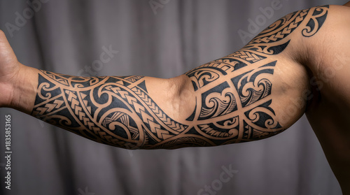 Artistic Maori tribal tattoo design covering a man's arm, showcasing intricate patterns and cultural symbolism