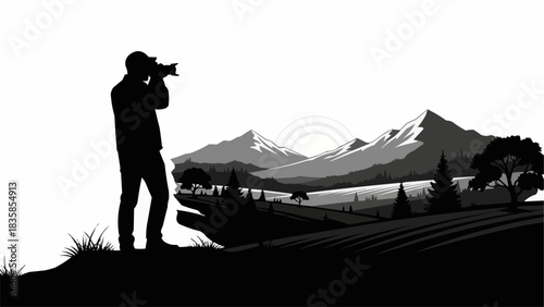 Silhouette of a photographer capturing a scenic mountain landscape.