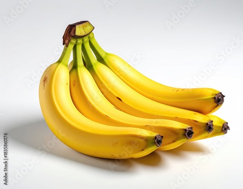 Bunch of ripe yellow bananas on a white surface