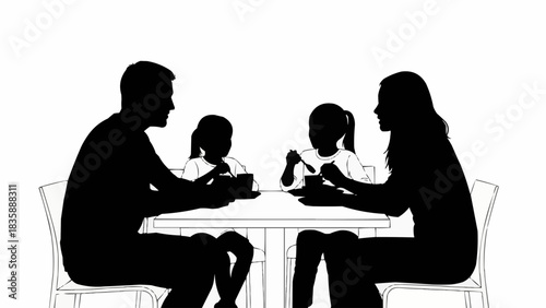 Family enjoying a meal together at the dining table in silhouette.